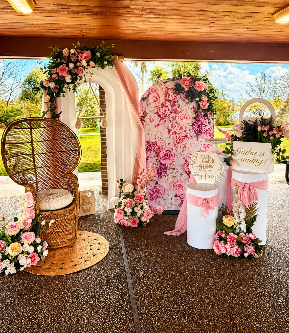 Pastel floral arch and cake table styled for a celebration