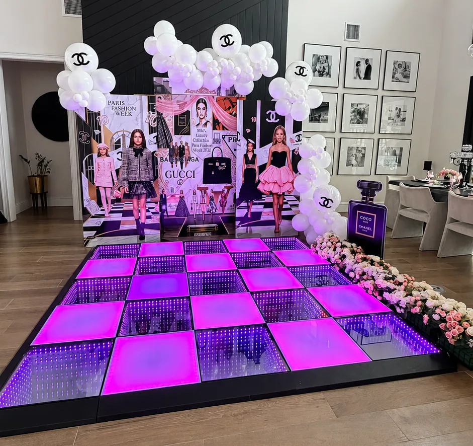 Playful kids party setup with a lit dance floor and balloon accents